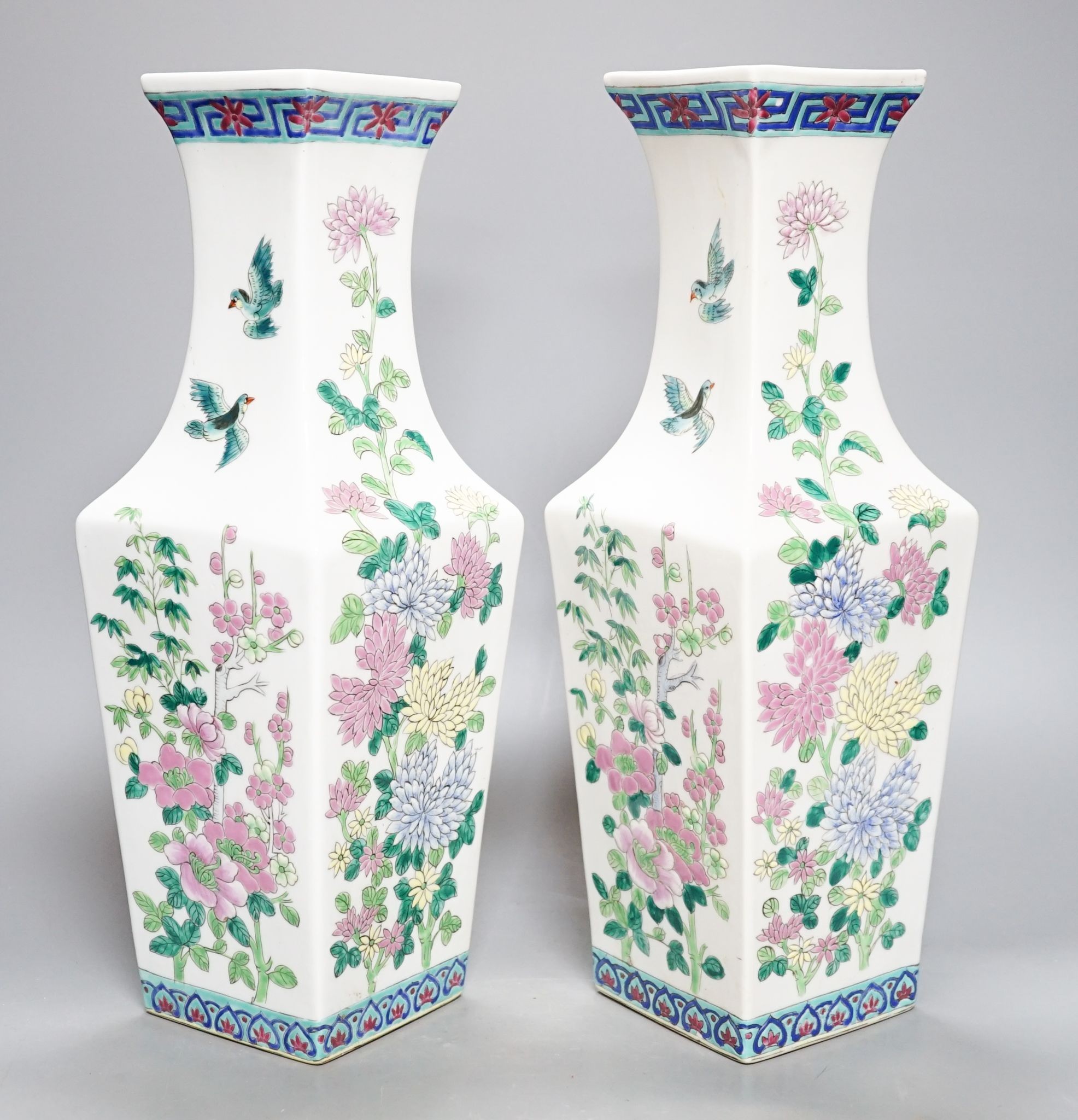 A pair of Chinese famille rose square baluster vases, and another famille rose vase, 37cm